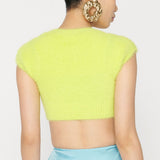 Back view of a woman wearing a lime green fuzzy cropped top.