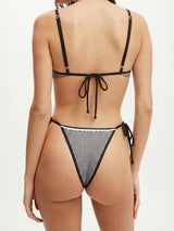 back view of a woman wearing a black and white gingham bikini