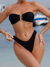 woman wearing a black strapless bikini with gold hardware