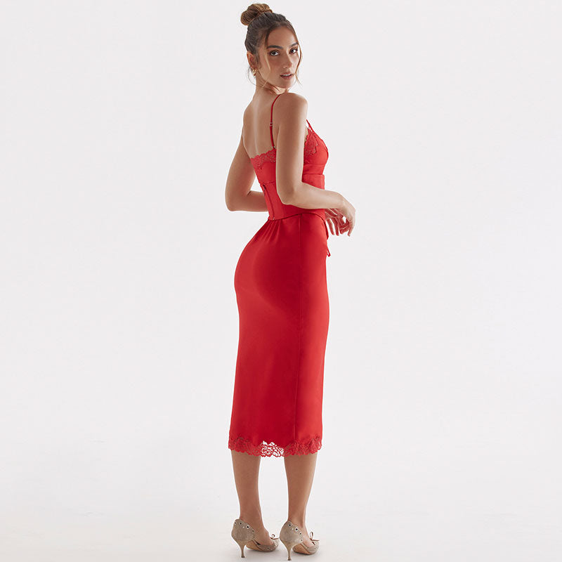 A woman in a red satin midi dress with lace trim and corset detailing is shown from the back against a white background.