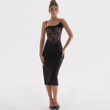 Model wearing a black midi dress with a lace bodice and floral embellishment.