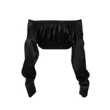 A black satin off-the-shoulder cropped top with ruched detailing and long sleeves, shown flat.
