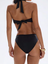 back view of a woman wearing a black bikini