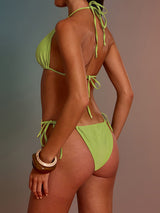 side view of a woman in a lime green bikini