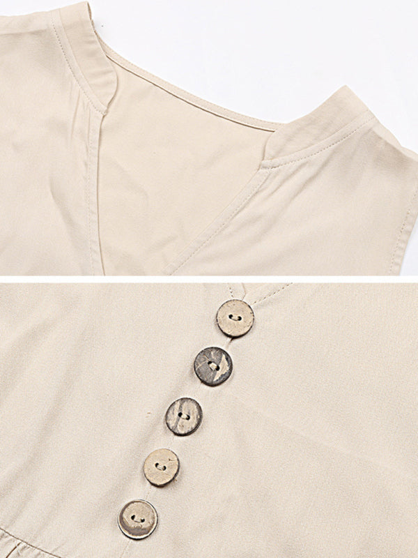 close-up of the v-neckline and button details on the beige dress