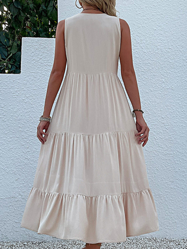 back view of a woman wearing a beige tiered midi dress