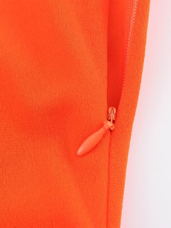 Close-up of orange dress zipper