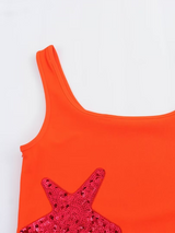Close-up of orange dress scoop neck and sequined star applique