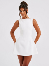 woman in white sleeveless mini dress with boat neckline and pockets
