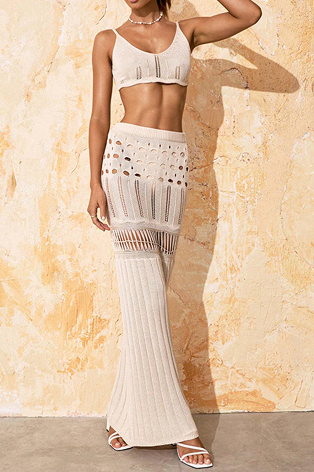 Full body front view of a woman wearing a cream crochet knit two-piece set, showcasing the maxi length skirt and cropped top.