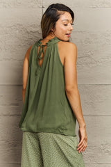 back view of an olive green halter top with a keyhole tie closure