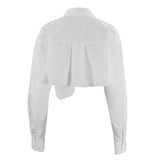 Back view of a white cropped button-up shirt with a collar and pleated back detail