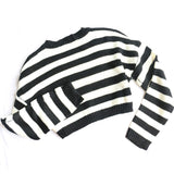 A black and white striped cropped sweater laid flat on a white background, showing the back.
