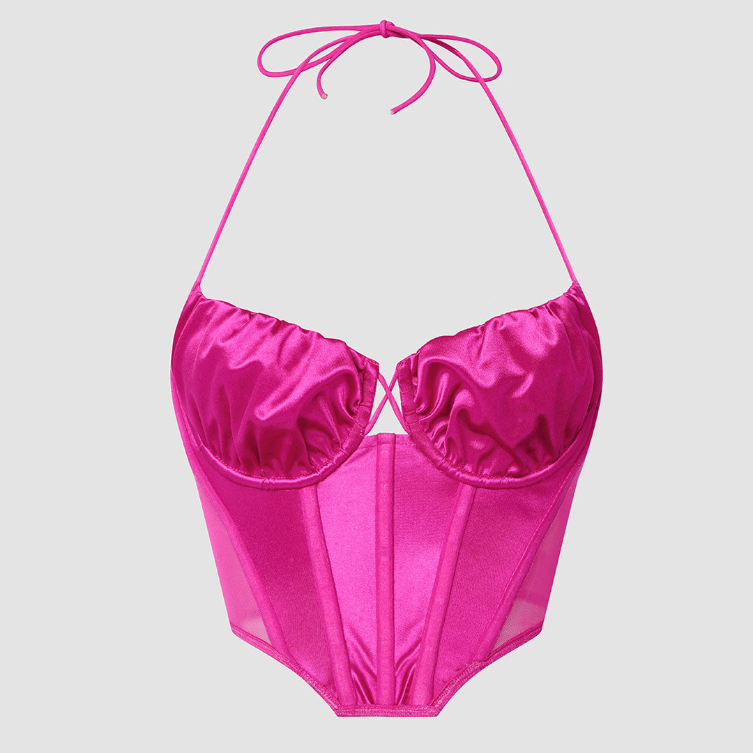 A fuchsia halter neck corset top with sheer panels and ruching.