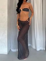 woman wearing a black and white polka dot bikini and a matching sheer maxi skirt