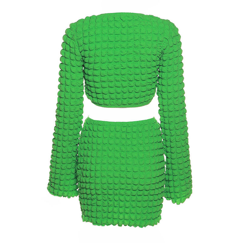 Back view of a green textured crop top and mini skirt set.