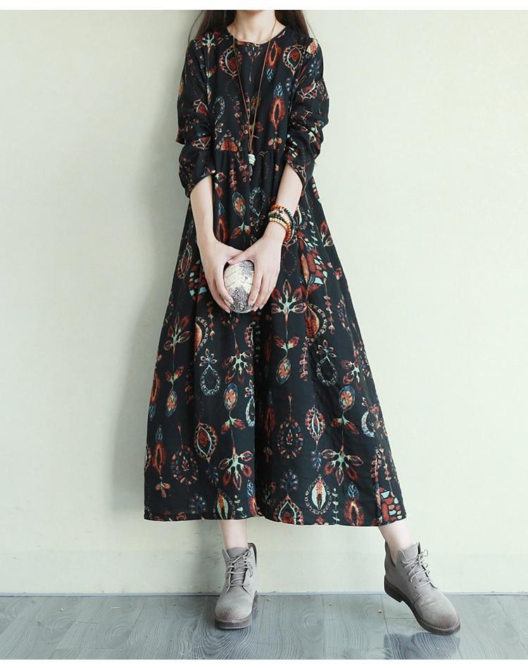 Woman wearing a black floral print midi dress holding a decorative ball