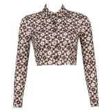 Front view of a brown and white patterned long-sleeved cropped shirt with a collared neckline and button-up front.