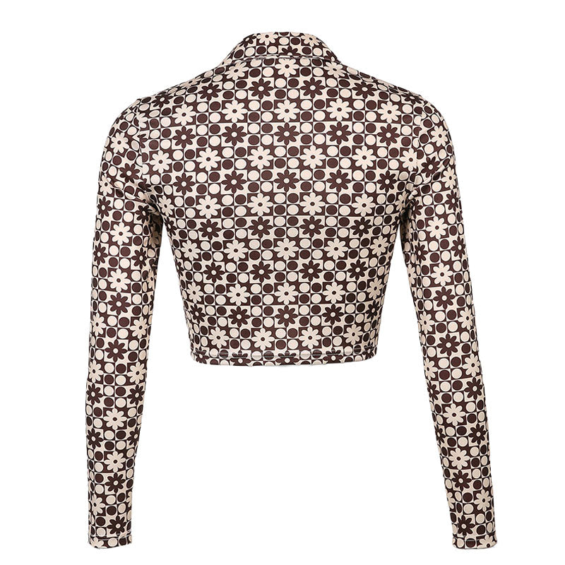 Back view of a brown and white patterned long-sleeved cropped shirt with a collared neckline.