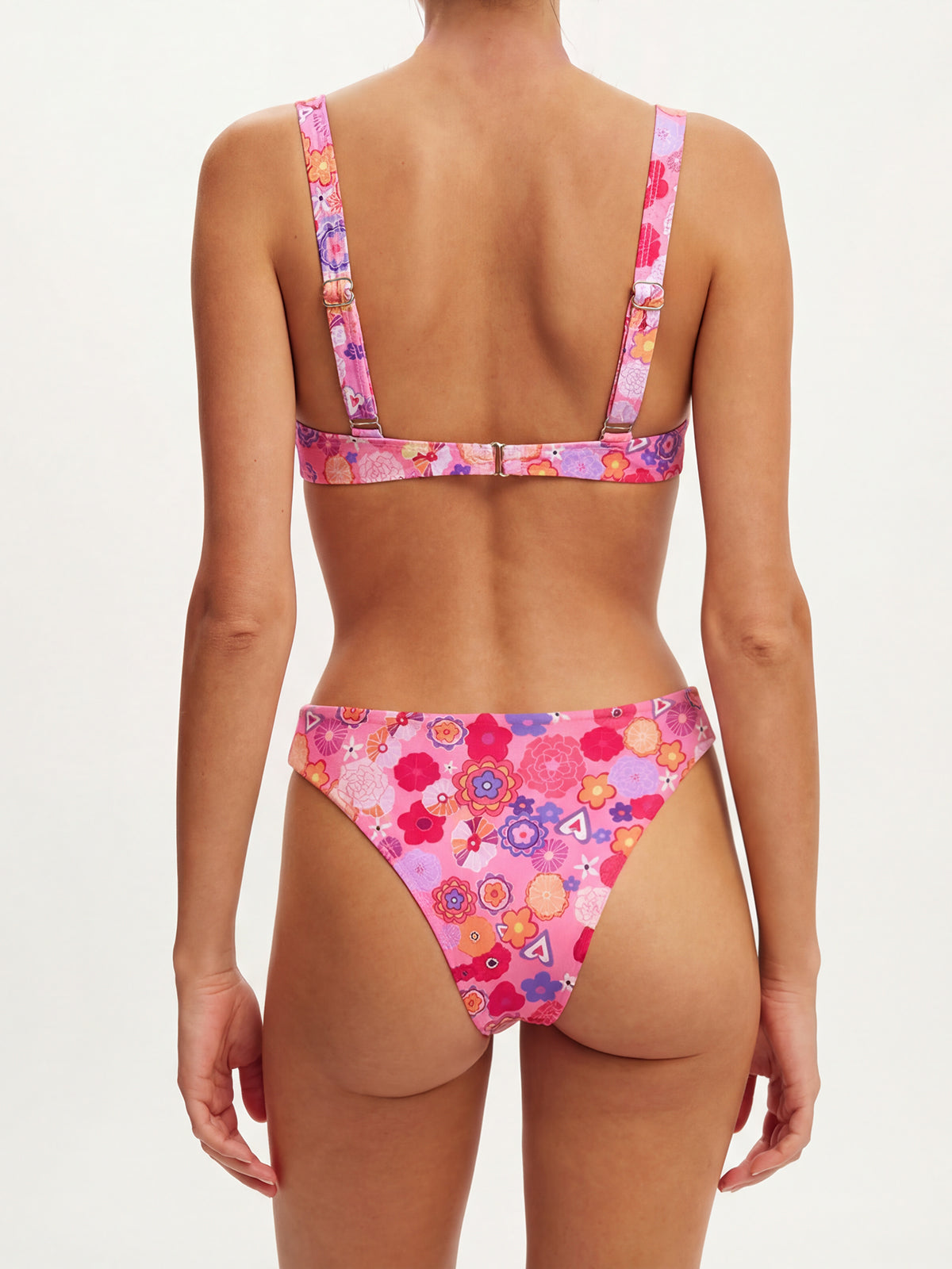Back view of a woman wearing a pink floral print bikini.