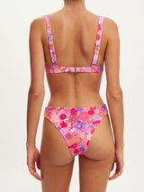 Back view of a woman wearing a pink floral print bikini.
