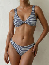 woman wearing a blue and white striped bikini with a knotted top and high-waisted bottoms