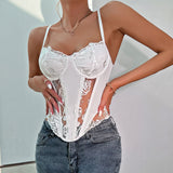 Woman wearing a white lace corset top with sheer panels and floral embroidery, paired with grey jeans.