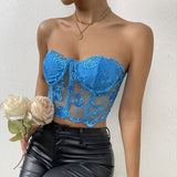 Close-up of a woman in a blue strapless lace corset top with intricate floral patterns.