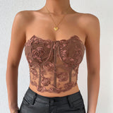 front view of a woman in a brown floral lace corset top