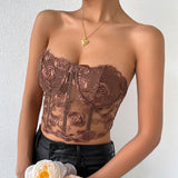 close-up of a woman's torso wearing a brown floral embroidered corset top