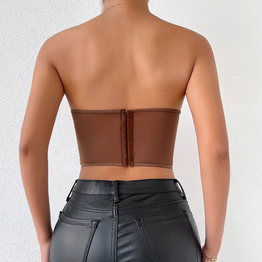 back view of a woman wearing a brown strapless corset top with a zipper closure