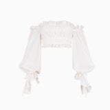 White off-the-shoulder crop top with ruffled neckline and billowy sleeves, front view, on white background