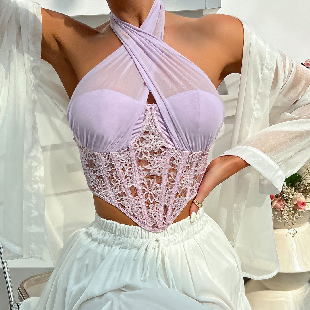 Close-up of a woman in a lavender halter top with intricate white lace detailing.