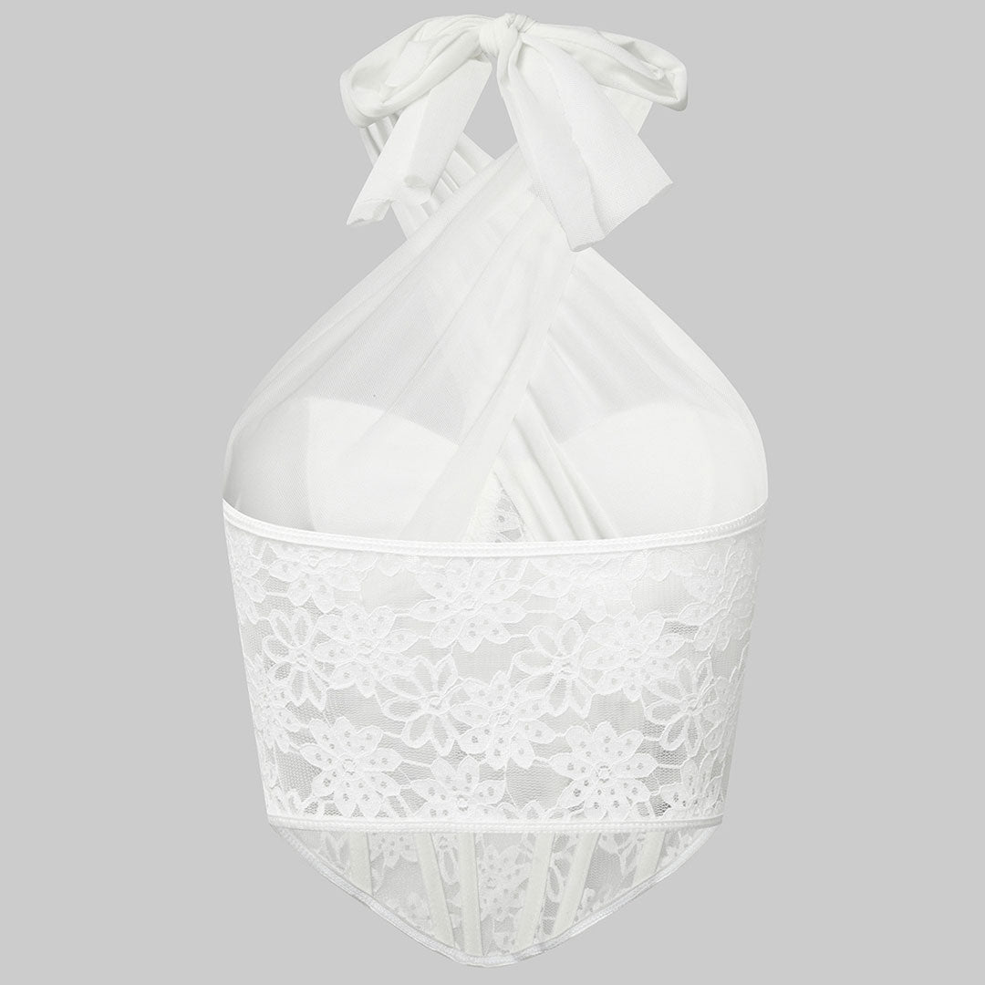 Front view of a white lace corset top with a halter neck and sheer fabric.