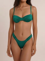 A woman wearing a forest green ruched bikini set.