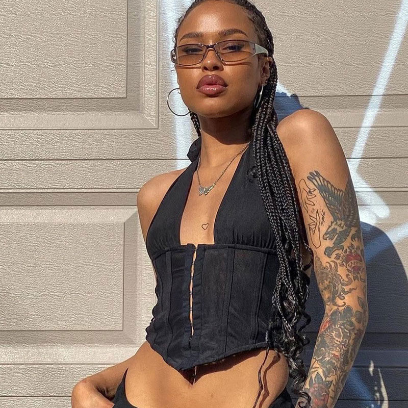 woman wearing a black halter corset top and sunglasses