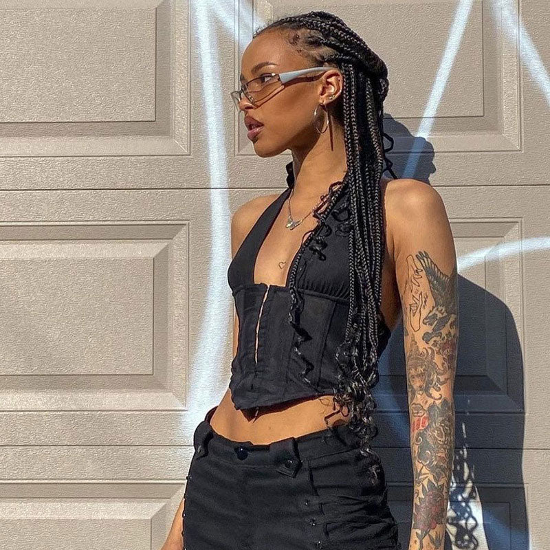 woman wearing a black halter corset top and sunglasses, profile view