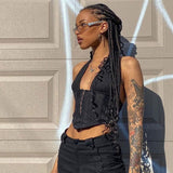 woman wearing a black halter corset top and sunglasses, profile view