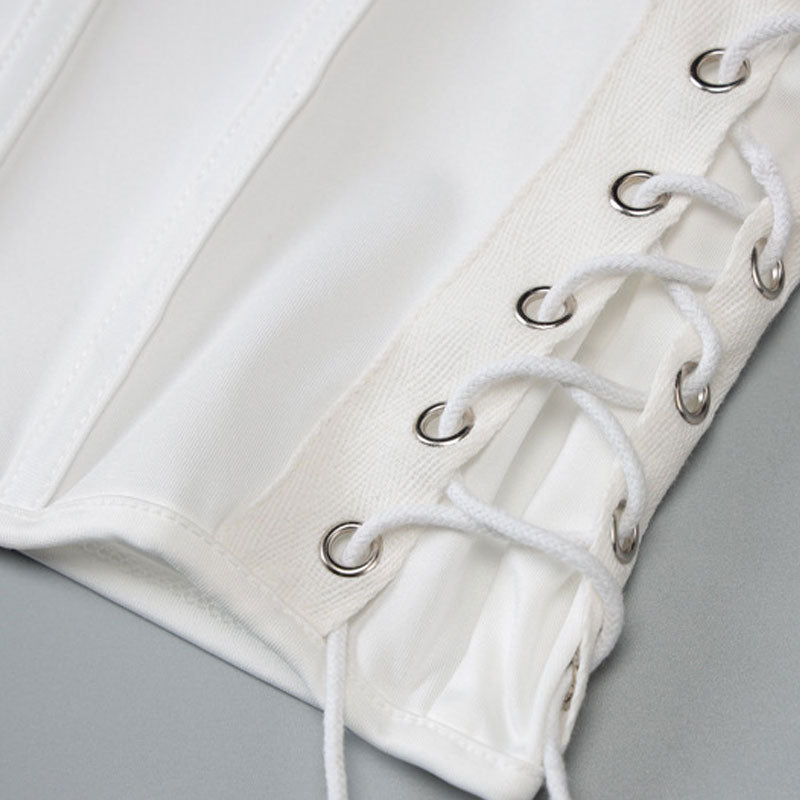 close-up of white fabric with lace-up detailing and grommets