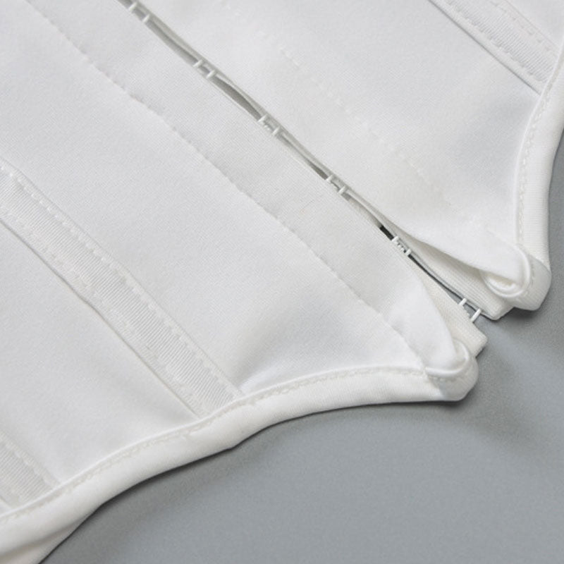 Close-up of the front closure and boning detail on a white halter top.