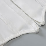Close-up of the front closure and boning detail on a white halter top.