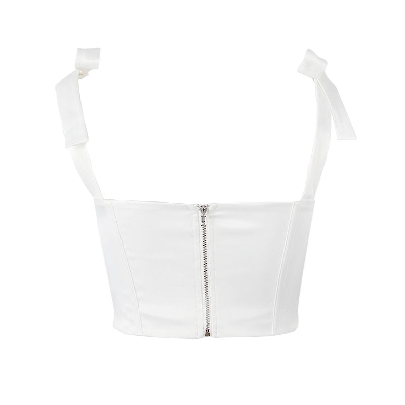 A back view of a white corset top with a zipper
