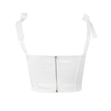 A back view of a white corset top with a zipper