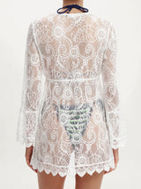 Back view of a white lace cover-up showing the intricate pattern