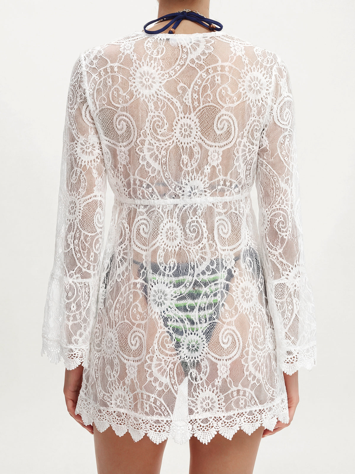 Back view of a white lace cover-up showing the intricate pattern