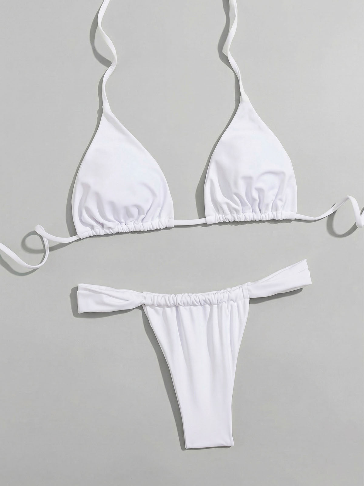 white bikini top and bottom laid out