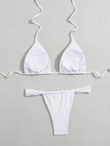 white bikini top and bottom laid out, showing the inside of the top