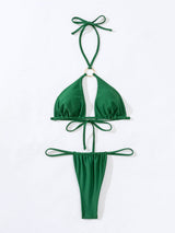 Flat lay of a green bikini with a gold ring detail