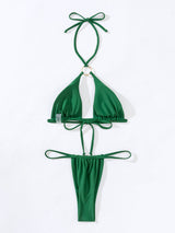 Flat lay of a green bikini with a gold ring detail