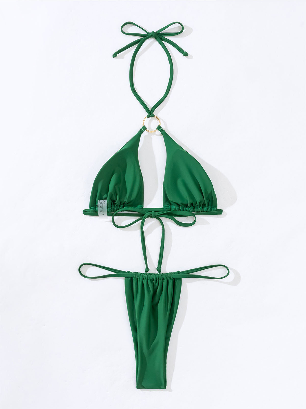 Flat lay of a green bikini with a gold ring detail